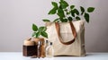 Open eco-friendly cotton reusable bag with different containers from natural wood and brown glass.Fresh natural leafs around.