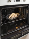 open electric oven with hot air ventilation. New oven. Door is open and light is on. vertical Royalty Free Stock Photo