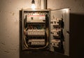 An open electrical panel box with a variety of circuit breakers and colorful wires organized Royalty Free Stock Photo