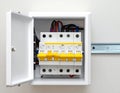 Open electrical panel showing circuit breakers, wiring, and a metal rail inside a white box Royalty Free Stock Photo