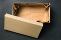 Open empty box with a lid, isolated on a black background. Cardboard box for shoes or gift. Top view, flat layout