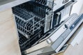 Open empty dishwasher machine close-up in modern kitchen Royalty Free Stock Photo
