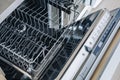Open empty dishwasher machine close-up in modern kitchen Royalty Free Stock Photo
