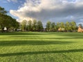 Open empty field taken at a village park late afternoon in summer Royalty Free Stock Photo