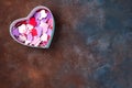 Open empty gift box with a hearts shape on stone background, flat lay. Royalty Free Stock Photo