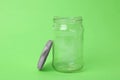 Open empty glass jar on green background Royalty Free Stock Photo