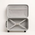 Open empty modern hardshell suitcase top view on white background neat interior lining straps and pockets travel packing concept Royalty Free Stock Photo