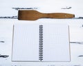 Open empty notebook in a box and a kitchen spatula Royalty Free Stock Photo