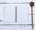 Open empty notebook in a box and a kitchen spoon Royalty Free Stock Photo