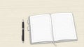 Open blank notebook with lined pages and a black pen on a light background Royalty Free Stock Photo