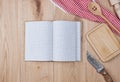 Open empty notebook with white sheets and a kitchen wooden spoon Royalty Free Stock Photo
