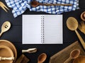 open empty paper notebook with white sheets in a line on a spring in the middle of wooden kitchen items Royalty Free Stock Photo