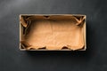 Open empty Shoe box, isolated on a black background. Crumpled brown paper. Royalty Free Stock Photo