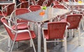 Open empty street cafe, tables and chairs with metal frame and wicker furniture, selective focus and close-up Royalty Free Stock Photo