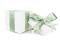 Open empty white Christmas gift box with frosty green bow and ribbon isolated on white