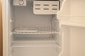 Open empty white refrigerator on defrost close up without food Royalty Free Stock Photo