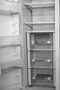Open empty white refrigerator. Side View of Stainless Steel Double Door Refrigerator. Royalty Free Stock Photo