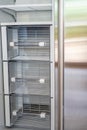 Open empty white refrigerator. Side View of Stainless Steel Double Door Refrigerator. Royalty Free Stock Photo