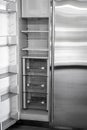 Open empty white refrigerator. Side View of Stainless Steel Double Door Refrigerator. Royalty Free Stock Photo