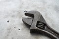 Open end adjustable wrench spanner on metal table background