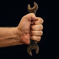 Open-end wrench in dirty workers hand isolated Royalty Free Stock Photo