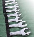 Open end wrench set on green cover on sunlight. Close up Royalty Free Stock Photo