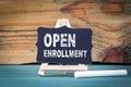 Open Enrollment. small wooden board with chalk on the table