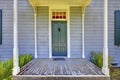 Open entrance porch with columns and blue door of an old house in Lakewood, WA. USA Royalty Free Stock Photo