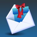 Open envelope with gift box and red bow Royalty Free Stock Photo