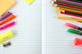 Open exercise book with pens and pencils Royalty Free Stock Photo