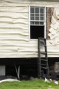 Ladder At A Window With Heat Damaged Plastic Vinyl Siding From An Structure Fire Royalty Free Stock Photo