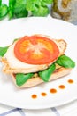 Open-face sandwich with chicken, mozzarella, tomato, pesto and basil on toasted ciabatta, vertical Royalty Free Stock Photo