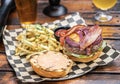 Open Faced Bacon Cheese Burger with Garlic Fries and Beer Royalty Free Stock Photo