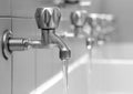 Open faucets with water flowing in the bath changing rooms