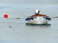 Open fibre glass boat, Garvel Built style, with outboard moored in a little cove at Donaghadee, Co Down. Royalty Free Stock Photo