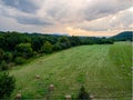 An open field with hey bales overlooking the Shenandoah Valley with warm colored clouds at sunset near Front Royal, Virginia, USA Royalty Free Stock Photo