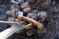 Open fire in the grill to grill a sausage with a charcoal Royalty Free Stock Photo