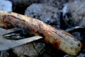 Open fire in the grill to grill a sausage with a charcoal barbecue in the garden Royalty Free Stock Photo