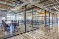 An open floor plan office featuring glass walls and open meeting spaces for easy communication Royalty Free Stock Photo