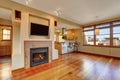 Open floor plan. View of fireplace in the living room with hardwood floor.