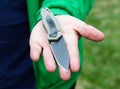 Open folding knife lies on the man`s palm Royalty Free Stock Photo