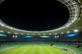 An open football stadium with empty stands with green seats. Royalty Free Stock Photo