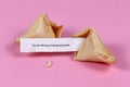 Open fortune cookie with motivational text `You are vibrating of energy and power`