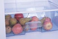 Open fridge, apples and pears on the shelf of refrigerator, heal