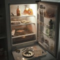 Open fridge with food items and beverages inside Royalty Free Stock Photo