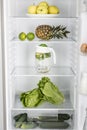 Open fridge full of fresh fruits and vegetables