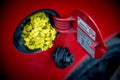 Open fuel tank lid in red car with rapeseed. Royalty Free Stock Photo