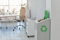 Open full trash bin in modern office. Waste recycling Royalty Free Stock Photo