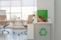 Open full trash bin in modern office. Waste recycling Royalty Free Stock Photo