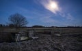 An open gate on a field in the night with a full moon Royalty Free Stock Photo